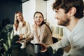 Young businesspeople colleagues having a coffee break in office, drinking and talking Royalty Free Stock Photo