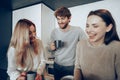 Young businesspeople colleagues having a coffee break in office, drinking and talking Royalty Free Stock Photo