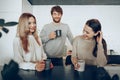 Young businesspeople colleagues having a coffee break in office, drinking and talking Royalty Free Stock Photo