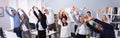 Young Office Workers Doing Stretching Exercise At Workplace