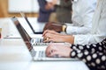 Young businesspeople hands working on their laptop on coworking place