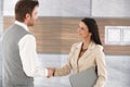 Young businesspeople shaking hands smiling Royalty Free Stock Photo