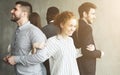 Young businesspeople standing in circle back to back and smiling Royalty Free Stock Photo