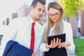 Young businesspeople using digital tablet outdoor Royalty Free Stock Photo