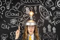 Young businesswoman against chalkboard with business sketch