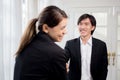 Young businesswoman and businessman break and talking with relax near window at office. Royalty Free Stock Photo