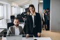 Young businesswoman and businessman working together in office and looking at the camera Royalty Free Stock Photo