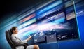 Young businesswoman in chair near tv