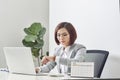 Young businesswoman checking time on her wristwatch at workplace. Time management Royalty Free Stock Photo