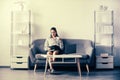 Young businesswoman with cup of coffee working on laptop with too much work in office. Secretary girl.