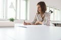 Young businesswoman or designer sitting at her office desk working on a project Royalty Free Stock Photo