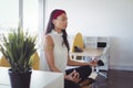 Young businesswoman doing yoga at office Royalty Free Stock Photo