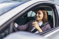 Businesswoman driving in a car to work during the day, drink coffee Royalty Free Stock Photo