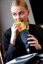 Young businesswoman eating a sandwich Royalty Free Stock Photo