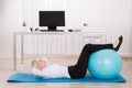 Businesswoman Exercising With Fitness Ball