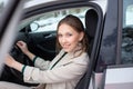 A young businesswoman is exiting a car