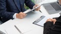 Young businesswoman explaining about her profile and holding resume during corporate meeting or job interview with applicant to Royalty Free Stock Photo