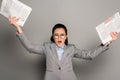 Young businesswoman in eyeglasses holding newspapers Royalty Free Stock Photo