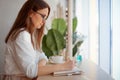 Young businesswoman in eyeglasses planning and writing down the daily schedule with in agenda Royalty Free Stock Photo