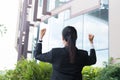 Young businesswoman feeling successful outside office building. Royalty Free Stock Photo