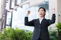 Young businesswoman feeling successful outside office building. Royalty Free Stock Photo