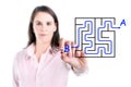 Young businesswoman finding the maze solution writing on the whiteboard. Royalty Free Stock Photo