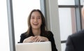 Young businesswoman giving a presentation to a young businessman boss with a smiling face. Royalty Free Stock Photo