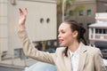 Young businesswoman hailing a cab