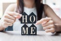 Young Businesswoman hands holding key and wooden Home model on table office. New House, Financial, Property insurance and real Royalty Free Stock Photo