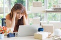 Young businesswoman having a headache while working on a laptop in the office. Feeling tired and stressed about her working Royalty Free Stock Photo