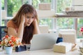 Young businesswoman having a headache working in the office. Feeling tired and stressed about her working problems. Royalty Free Stock Photo