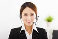 Young businesswoman with headset in office Royalty Free Stock Photo