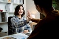 Young businesswoman high five coworkers at office