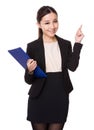 Young Businesswoman hold with clipboard and finger point up Royalty Free Stock Photo