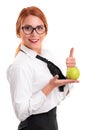 Young businesswoman holding apple and raising thumb up Royalty Free Stock Photo