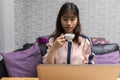 Young businesswoman holding a cup of coffee while sitting in front of laptop. home office and freelance concept Royalty Free Stock Photo