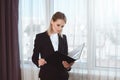 young businesswoman holding folder while standing Royalty Free Stock Photo