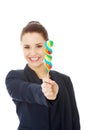 Young businesswoman holding a lolipop