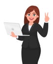 Young businesswoman holding a new digital laptop computer and showing victory, v, peace gesture sign. Female character design. Royalty Free Stock Photo