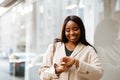 Young businesswoman looking at her wristwatch while walking outdoors Royalty Free Stock Photo