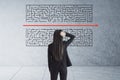 Young businesswoman looking on maze sketch with red arrow Royalty Free Stock Photo