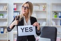 The young businesswoman with message in the office Royalty Free Stock Photo