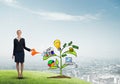Young businesswoman outdoors watering drawn growth concept with can Royalty Free Stock Photo