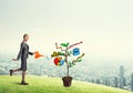 Young businesswoman outdoors watering drawn growth concept with can Royalty Free Stock Photo