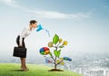 Young businesswoman outdoors watering drawn growth concept with can Royalty Free Stock Photo