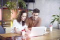 Young businesswoman with partners people gathered together, discussing creative idea in office. Using modern laptop, having coffe Royalty Free Stock Photo