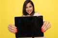 Young businesswoman in pink suit presenting empty screen Royalty Free Stock Photo