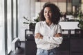 Young businesswoman portrait, Self confident young woman with crossed arms standing at office Royalty Free Stock Photo