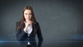 Young businesswoman portrait in suit standing and finger up near her lips with hush sign, background with copyspace. Royalty Free Stock Photo