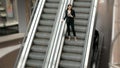 Young businesswoman portrait talking at the phone on escalators. Business woman full lenght in shopping mall or office